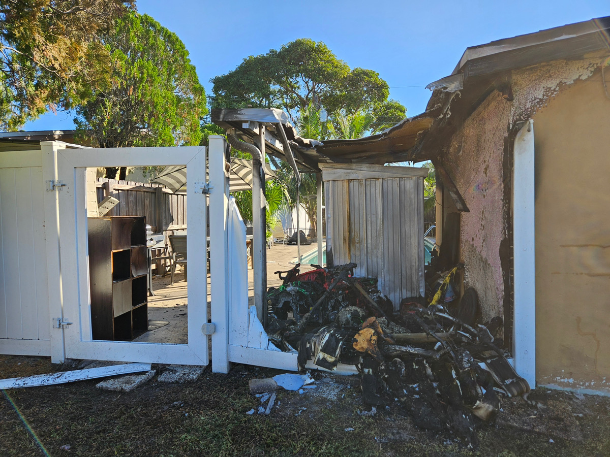 Exterior fire damage with charred framing and debris